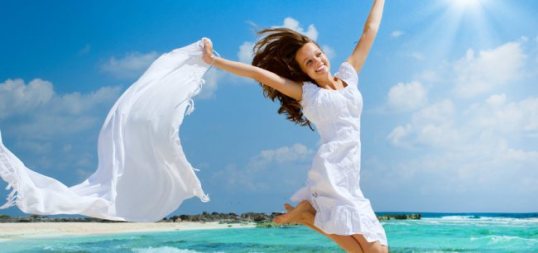 woman-white-beach-jump-850x400-1