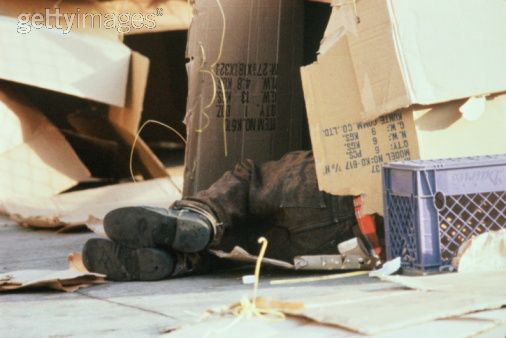 homeless person sleeping in cardboard box